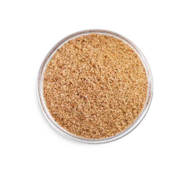 istock Brown salt in glass bowl isolated on white, top view 1421305631