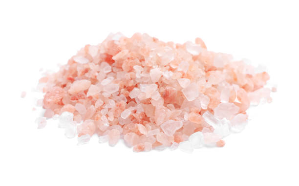 istock Heap of pink Himalayan salt on white background 1421305658