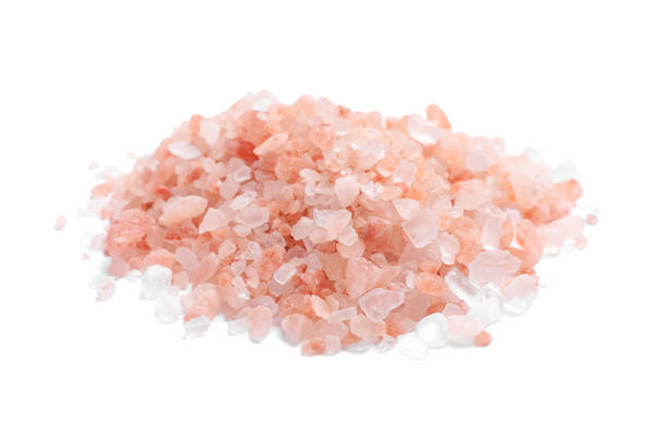 istock Heap of pink Himalayan salt on white background 1421305905