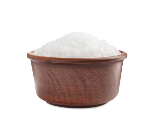 istock Natural salt in bowl isolated on white 1421306302