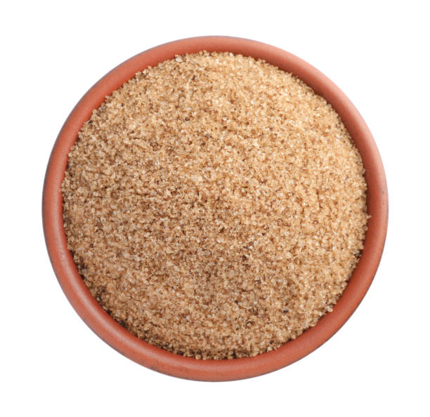 istock Brown salt in bowl isolated on white, top view 1421306696