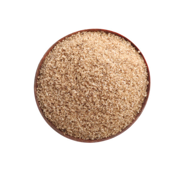 istock Brown salt in wooden bowl isolated on white, top view 1421307763