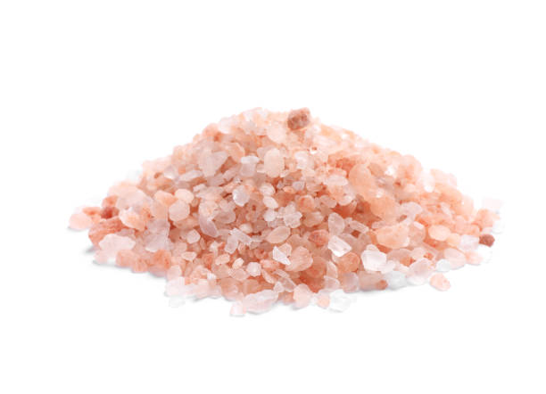 istock Heap of pink Himalayan salt on white background 1421307941