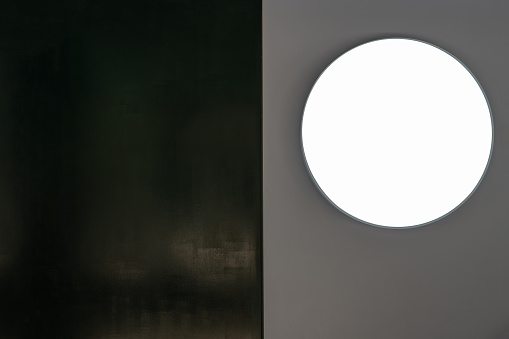 The round light box on the gray wall