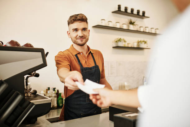 istock Barista Giving Napkins to Customer 1421308501