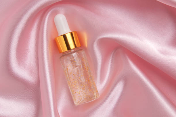 istock A face serum or natural essential oil lying on a pink fabric 1421308749