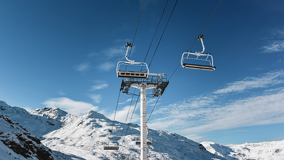 Ski lift in French Alps. Val Thorens ski resort. Chairlift in beautiful mountains. Sunny winter landscape.