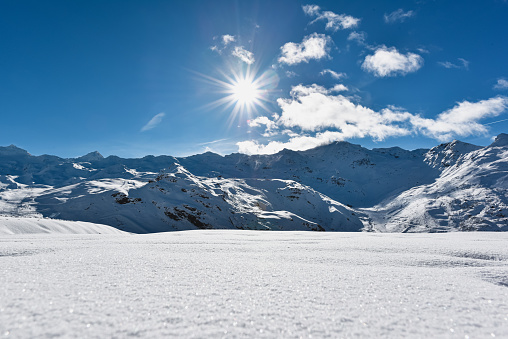 Sunny mountain landscape. View on snowy French Alps. Val Thorens ski resort.