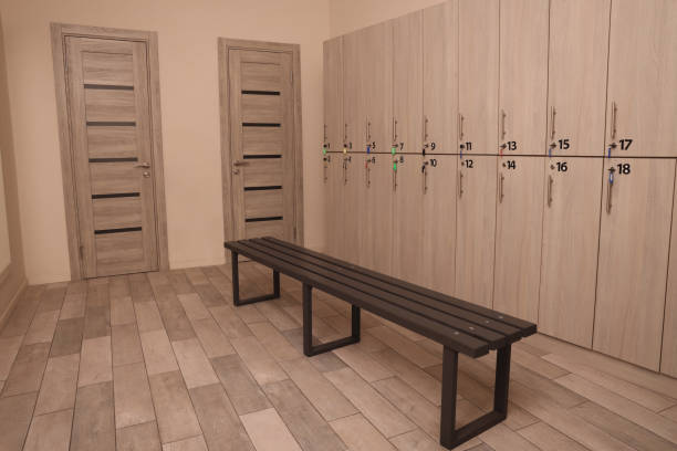istock Wooden bench and lockers in changing room interior 1421310691