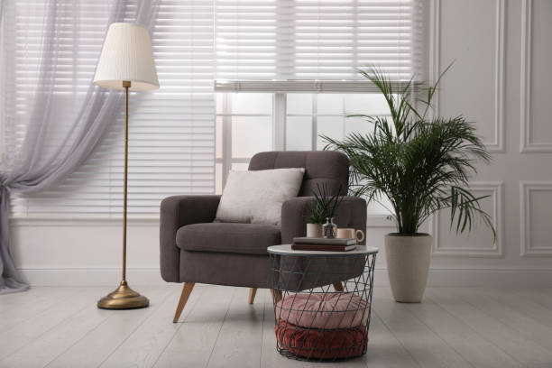 istock Comfortable place for rest with grey armchair near window indoors 1421310955