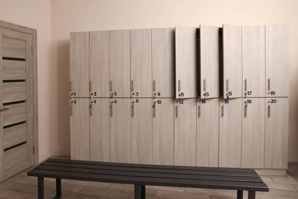 istock Wooden bench and lockers in changing room interior 1421311022