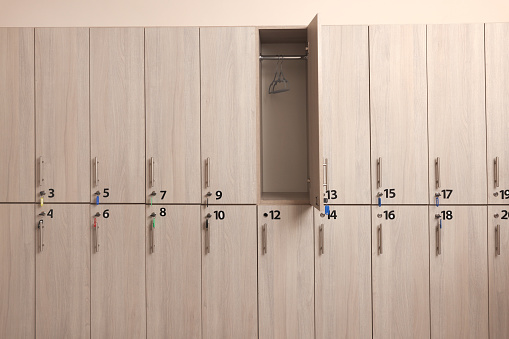 Many wooden lockers with keys and numbers on doors