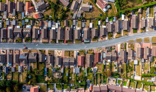 aerial view directly above a road through a suburban housing estate - characterless imagens e fotografias de stock
