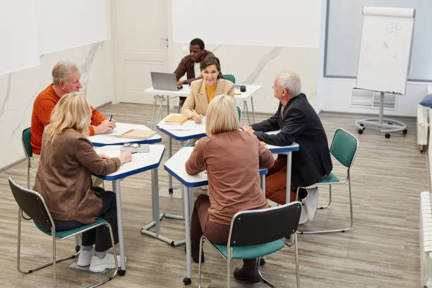 istock Group of students working in team at lesson 1421312792