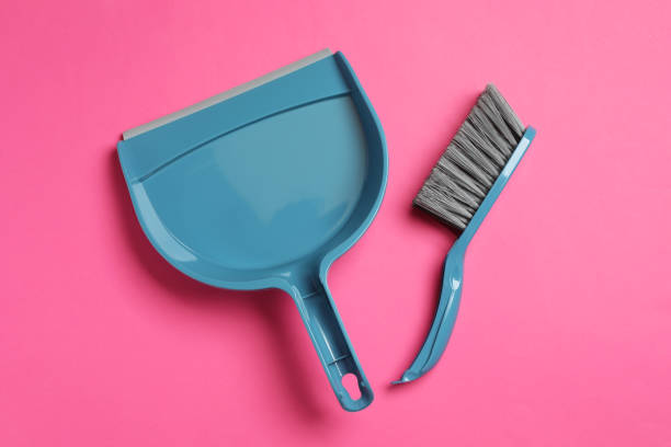 istock Plastic hand broom and scoop on pink background, flat lay 1421313282