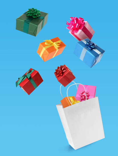 istock Many different gift boxes falling into paper shopping bag on light blue background 1421313755