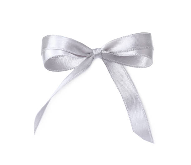 istock Silver satin ribbon tied in bow on white background, top view 1421313811