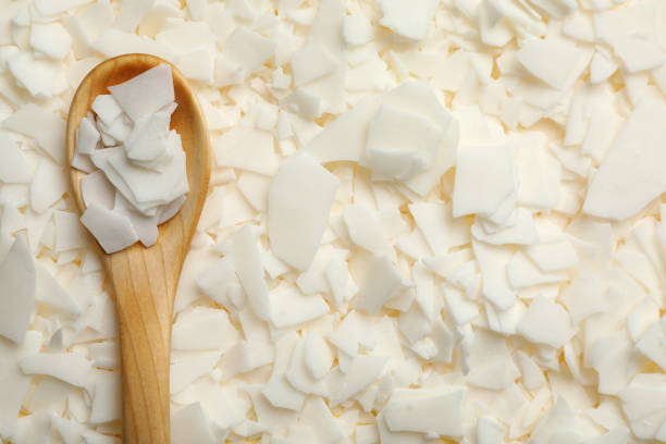 wooden spoon on heap of soy wax flakes, top view. homemade candle material - kerosene imagens e fotografias de stock