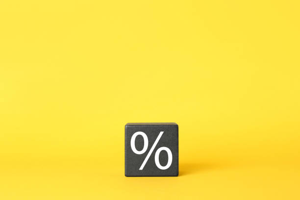 istock Black cube with percent symbol on yellow background. Space for text 1421315366