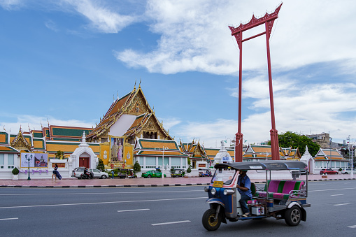 Bangkok Thailand July 2022, Wat Suthat Thepwararam Ratchaworahawihan temple in the old city of Bangkok with Tuk Tuk in front