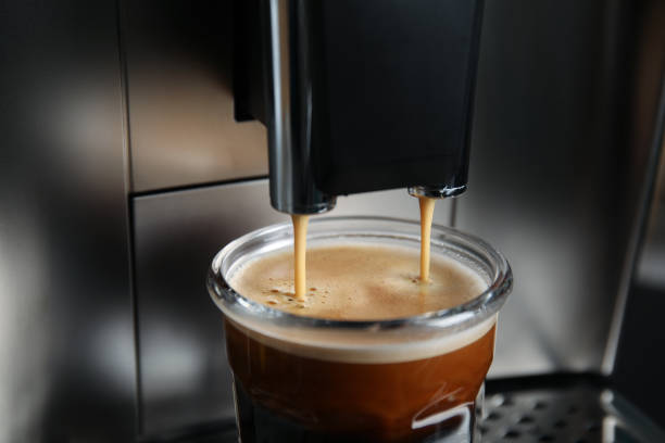 istock Espresso machine pouring coffee into glass, closeup 1421319989