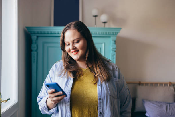 istock Plus Size Woman Browsing Her Social Media 1421320561