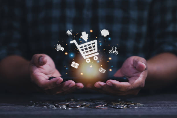 istock Hand holding virtual info graphics with trolley cart icons 1421321771
