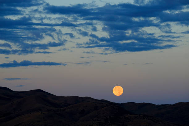 istock Moon Setting or Rising Over Mountains Orange Glow Twilight or Dusk 1421322754
