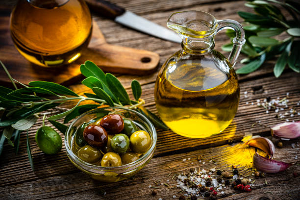 istock Extra virgin olive oil and olives still life 1421325439