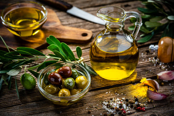 istock Rustic table with extra virgin olive oil and olives 1421325485
