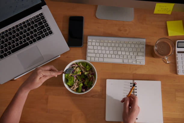 istock Woman Working and Eating Salad 1421330013
