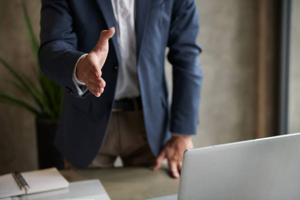 istock Entrepreneur Outstretching Arm for Handshake 1421330043