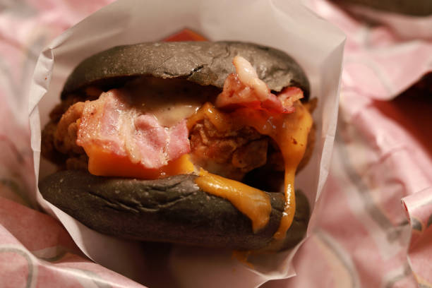 Crispy chicken burger with bacon an cheese close up