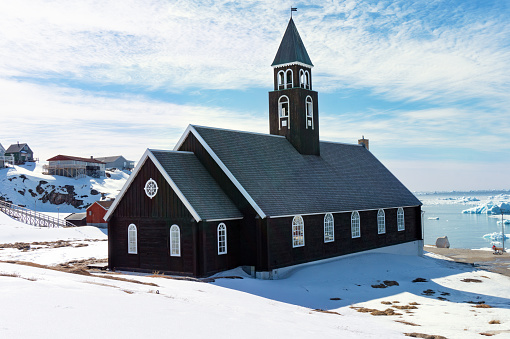 Zion church in Ilulissat Greenland with sunny snowy landscape .