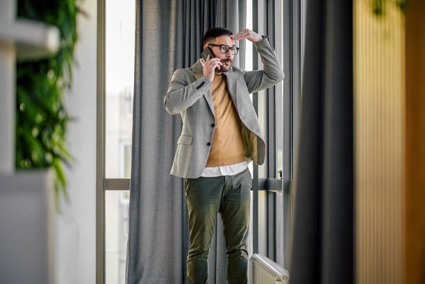 istock Mad young adult manager, touching his forehead, confused. 1421333809