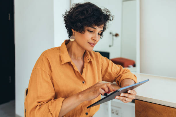 istock A Happy Beautiful Freelancer Reading Something On Social Networks Using Her Tablet 1421336388