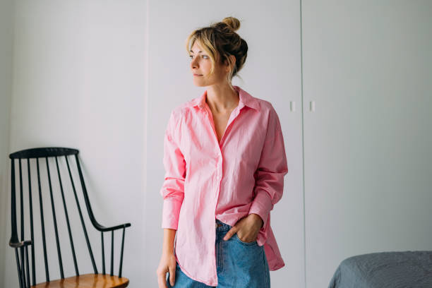 A smiling beautiful casually dressed Caucasian female relaxing at home.