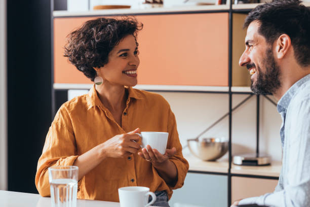 istock A Happy Couple Drinking Tea In The Kitchen And Talking 1421336523