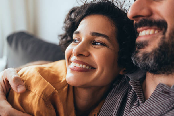 istock A Happy Beautiful Woman Looking Away While Enjoying Relaxing Together With Her Unrecognizable Boyfriend 1421336713
