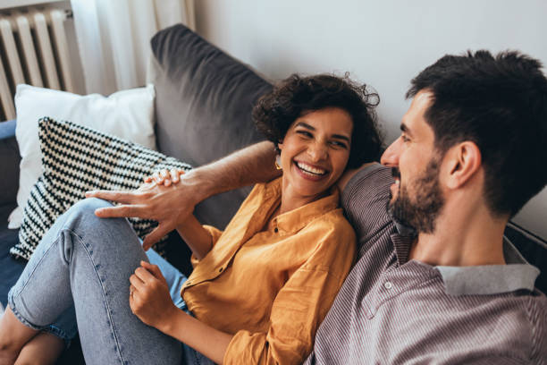 istock A Happy Couple Laughing While Sitting On The Cozy Sofa At Home And Relaxing 1421336742
