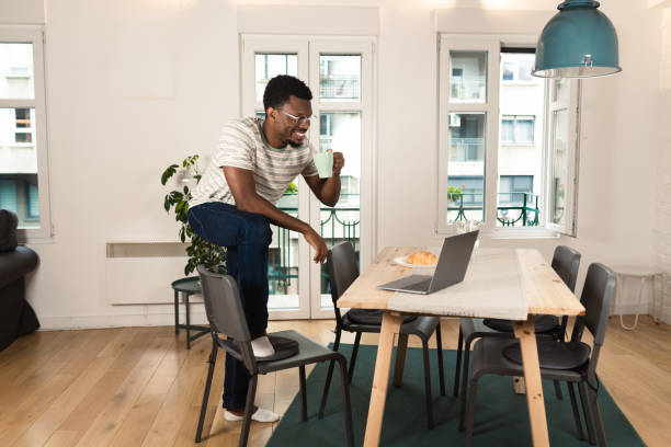 istock Young African-American programmer working at his home office 1421336913