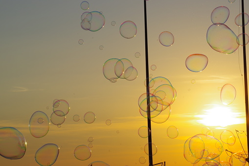 Photo taken in Viarreggio, Tuscany. A man sends soap bubbles into the air at sunset