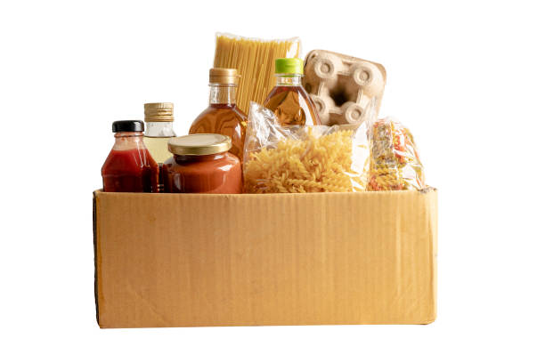 Foodstuff for donation, storage and delivery. Various food, pasta, cooking oil and canned food in cardboard box. Foodstuff for donation, storage and delivery. Various food, pasta, cooking oil and canned food in cardboard box. food staple stock pictures, royalty-free photos & images