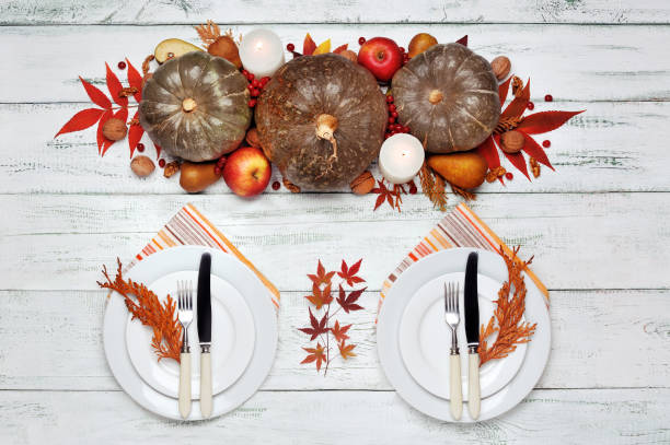istock Served two plates at the table decorated with pumpkins and autumn leafs 1421343656