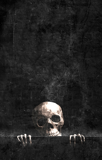Skeleton gripping the edge of a black grunge background.
