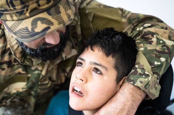istock Military soldier hugging his son with disability at home 1421345934