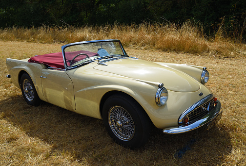 Little Gransden, Cambridgeshire, England - August 28, 2022:  Classic  Cream Daimler  Dart  Motor Car parked on grass.