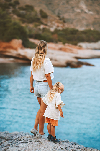 Mother and daughter travel together family summer vacations outdoor active healthy lifestyle mother with child enjoying sea view
