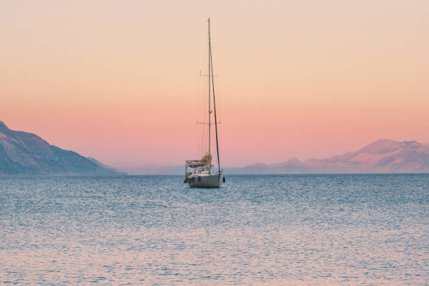Sailing boat in Aegean sea sunset landscape travel yachting tour cruise beautiful scenery stock photo