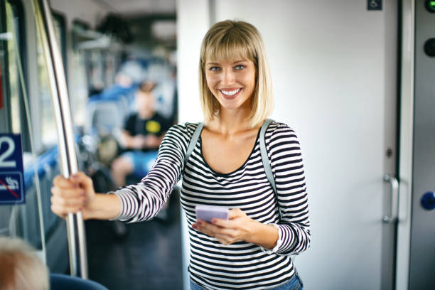 istock Young woman using smartphone while traveling by public transport. 1421351645